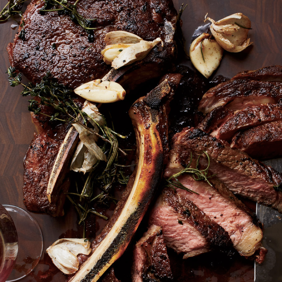 Juicy grass-fed beef steak with roasted garlic and herbs, available to order online.
