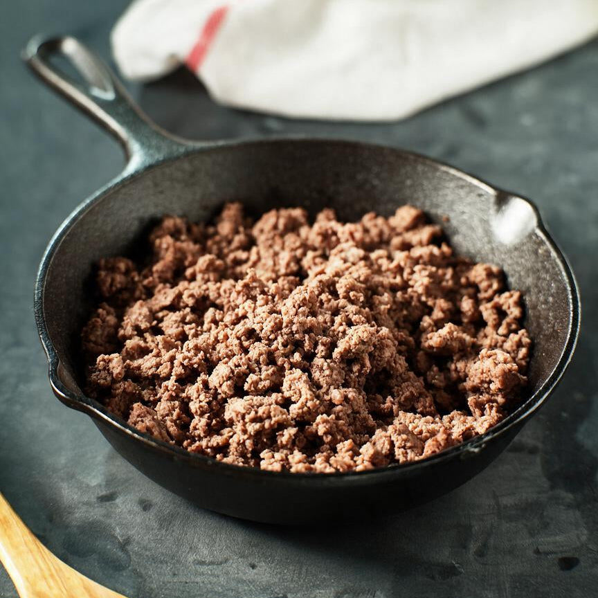 cast iron skillet with cooked grassfed ground beef
